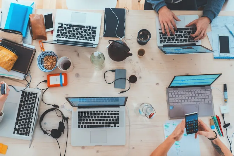 Team collaborating around laptops at a startup workspace